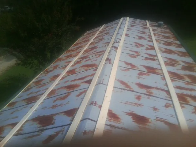 Rusted metal roof panels with new wood purlins before replacement — Storm Damage Roof Repair in Mathiston by Roofing Brothers